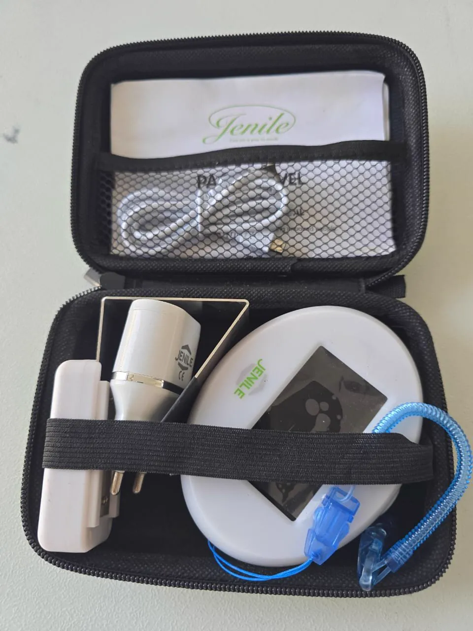 The Jenile Travel Pack open, with its alarm clock, door clip and pillow pad